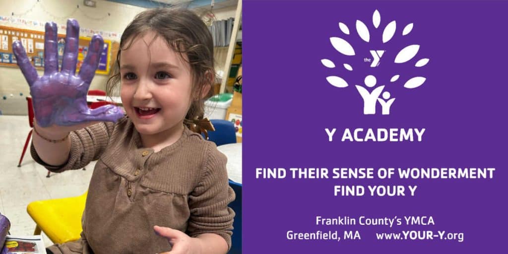 A promotional image for Y Academy at Franklin County’s YMCA features a smiling young child showing a hand covered in purple paint during an art activity. Beside the photo, the Y Academy logo appears with the message: “Find their sense of wonderment. Find your Y.” The location and website are listed as Greenfield, MA, and www.YOUR-Y.org.