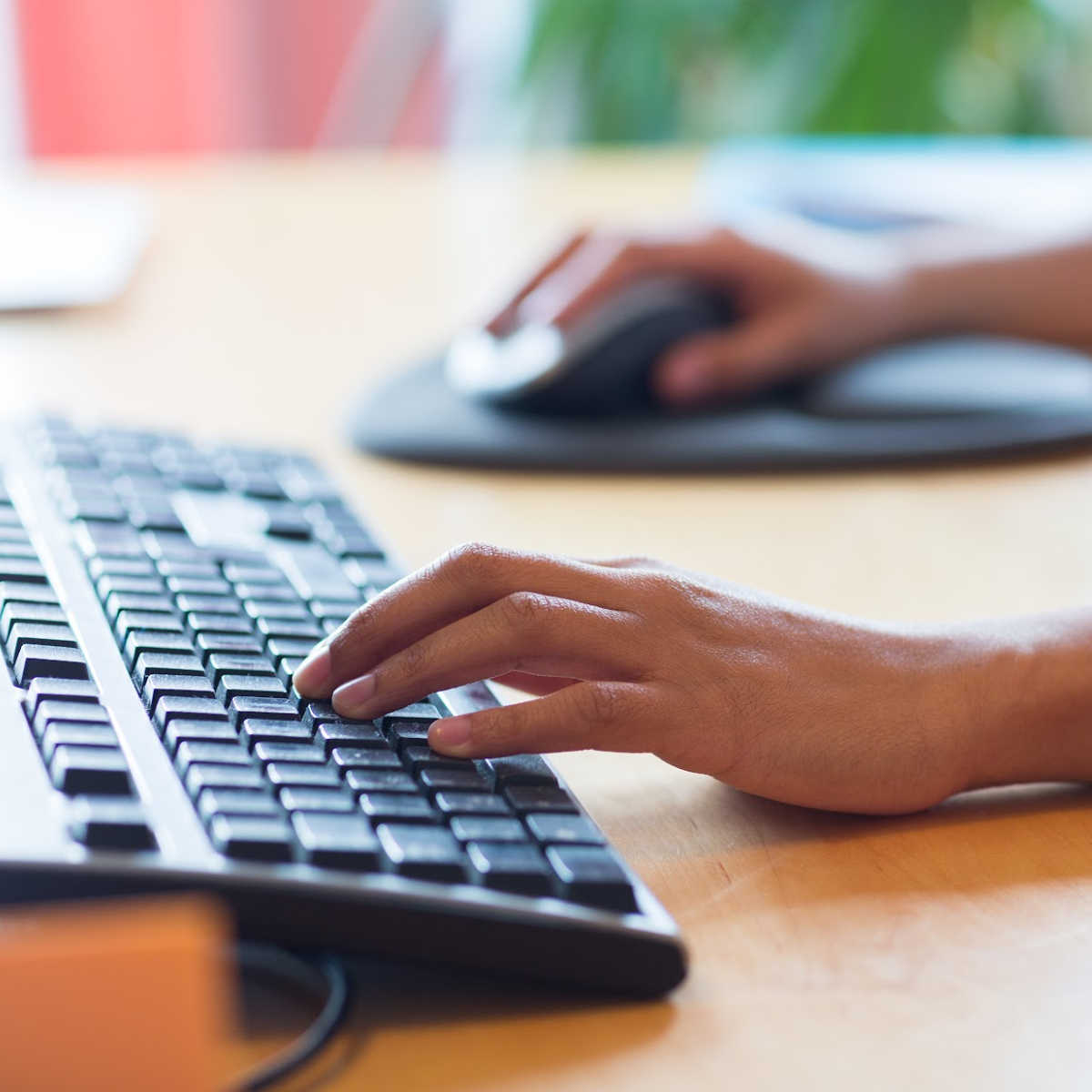 Hands move quickly across a keyboard, capturing ideas in motion and highlighting the everyday craft of digital writing.